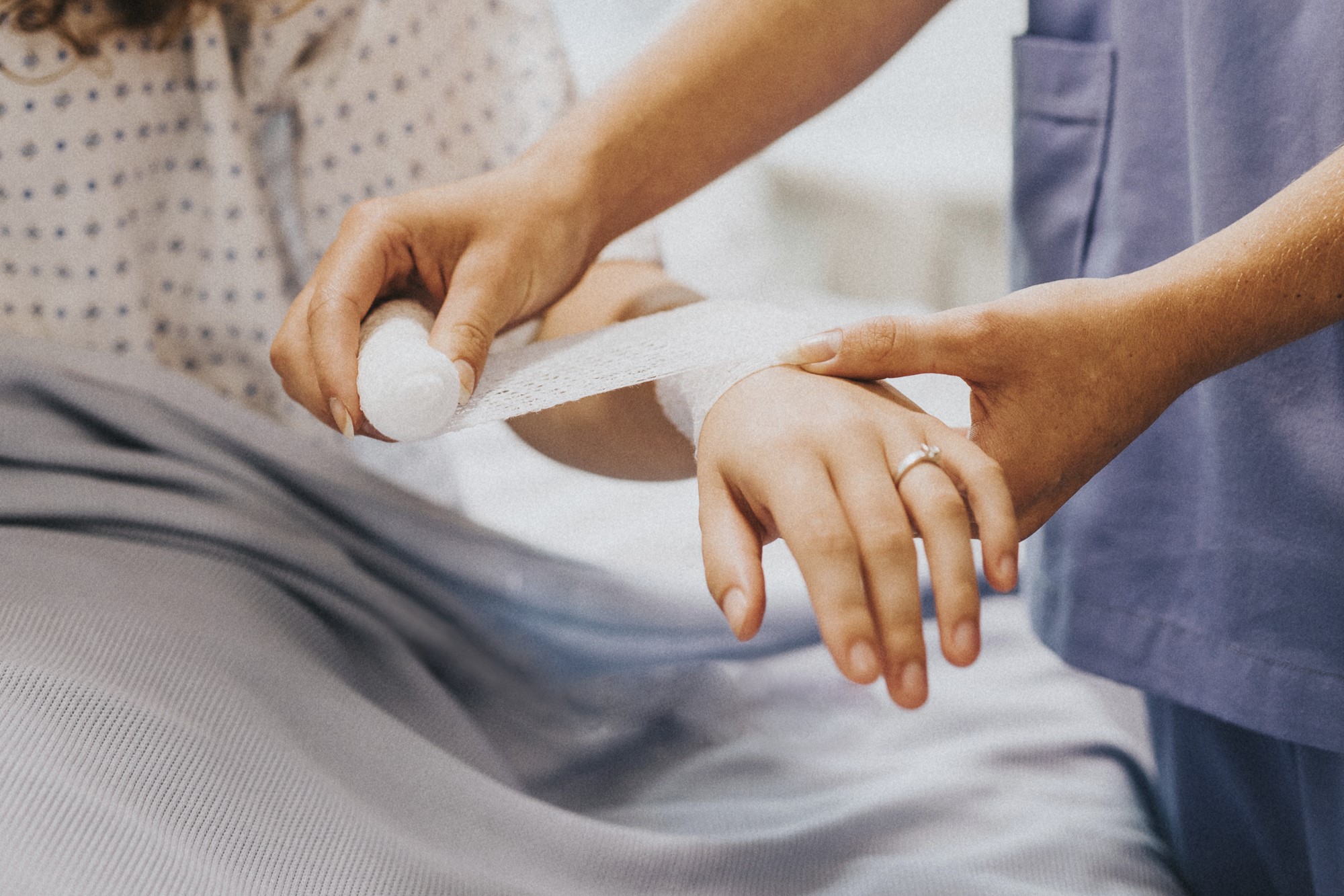 Nurse bandaging the patients arm
